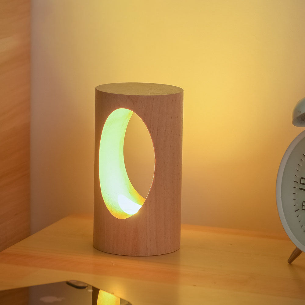 Lumen table lamp shown on a bedside table